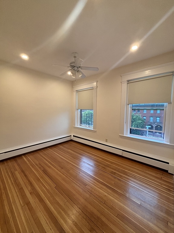 503 Park Drive, Unit 6 Boston, MA 02215 - Photo 4 of 9 an empty room with wooden floor and windows