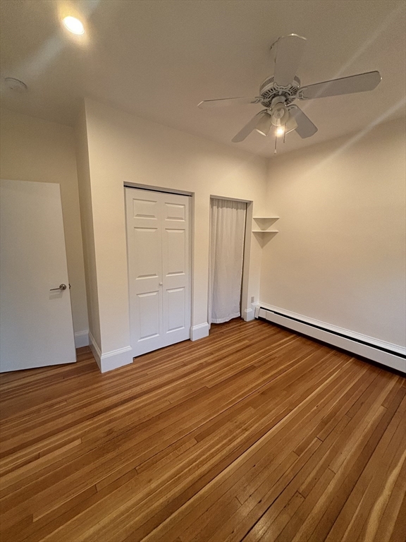 503 Park Drive, Unit 6 Boston, MA 02215 - Photo 5 of 9 wooden floor in an empty room with a chandelier fan