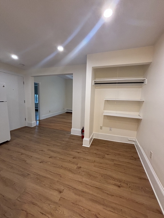 503 Park Drive, Unit 6 Boston, MA 02215 - Photo 6 of 9 a view of an empty room with wooden floor and a window