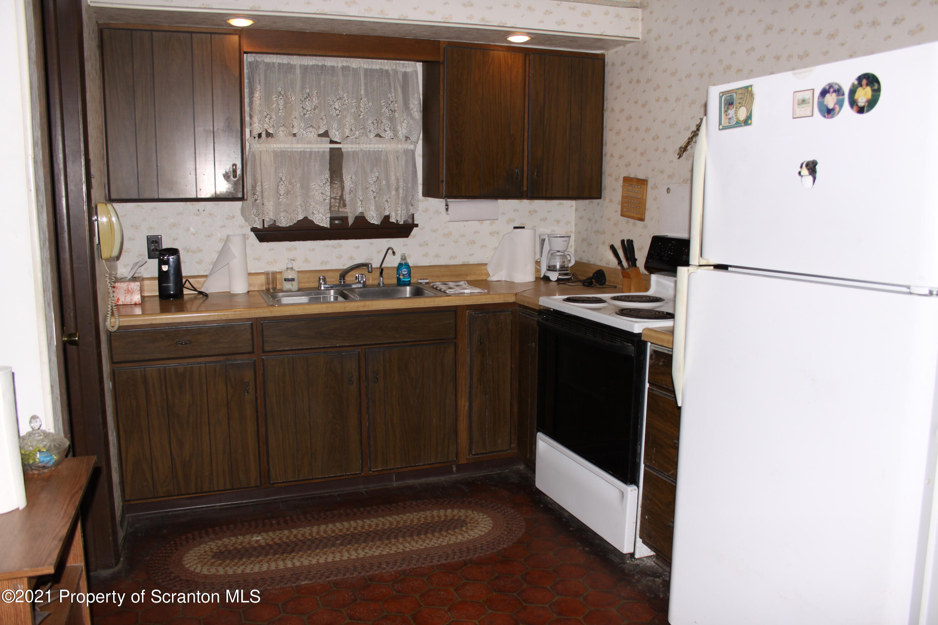 46 Cove Road Tunkhannock, PA 18657 - Photo 13 of 20 a kitchen with a sink a refrigerator and cabinets