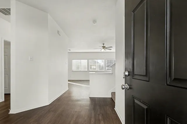 a view of hallway with wooden floor