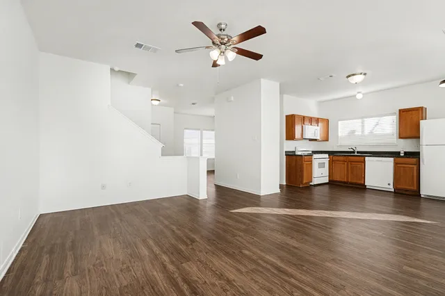 a view of kitchen with cabinets and wooden floor