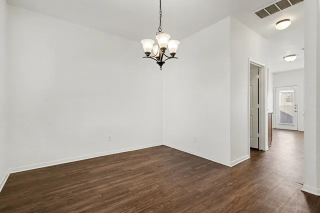 a view of a room with wooden floor