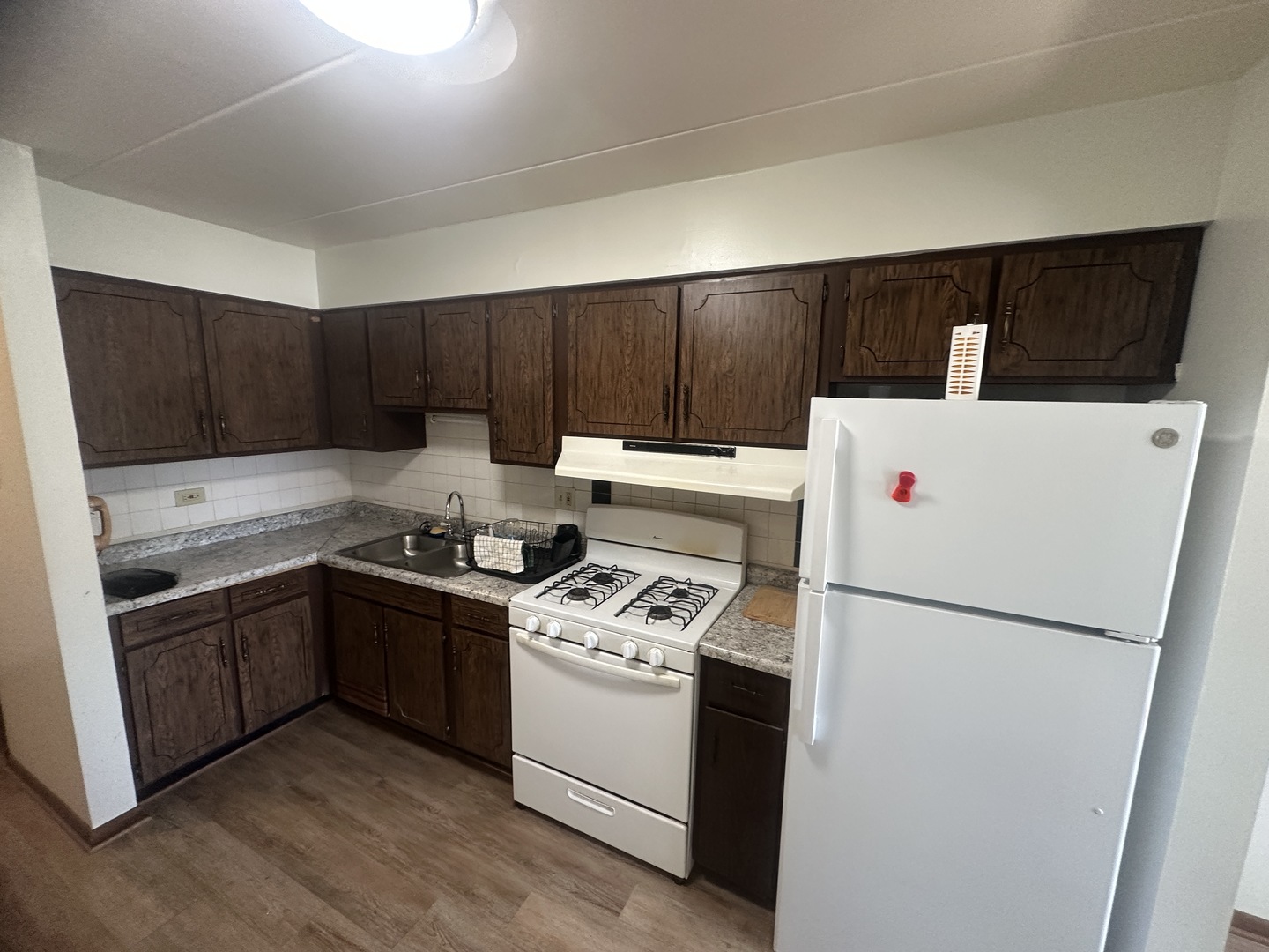 18550 Torrence Avenue, Unit 4 Lansing, IL 60438 - Photo 12 of 14 a kitchen with a stove a refrigerator and a sink