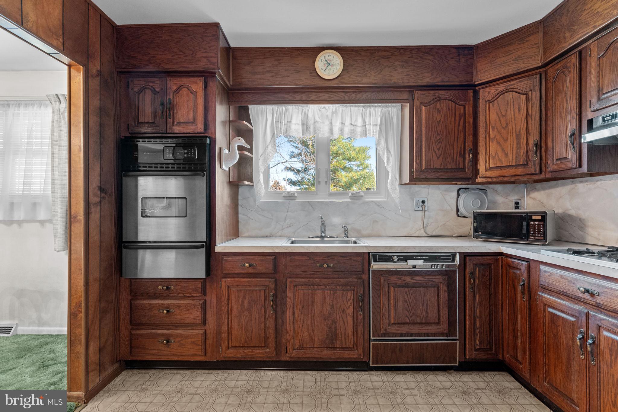 857 West County Line Road Warminster, PA 18974 - Photo 11 of 38 a kitchen with stainless steel appliances granite countertop a stove and a refrigerator