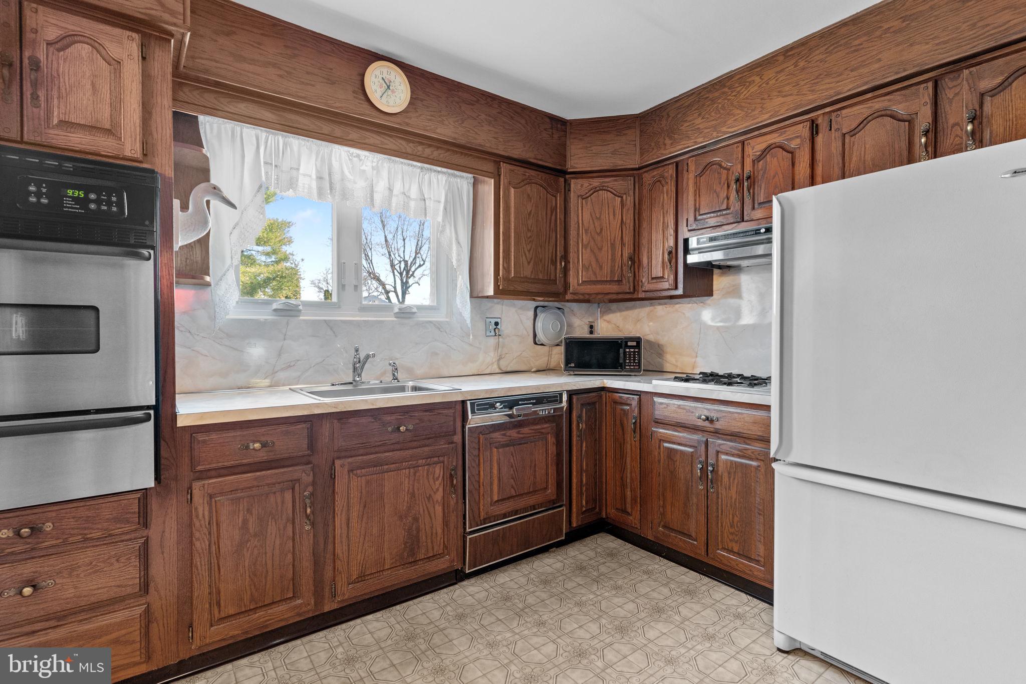 857 West County Line Road Warminster, PA 18974 - Photo 10 of 38 a kitchen with stainless steel appliances granite countertop a refrigerator sink and cabinets