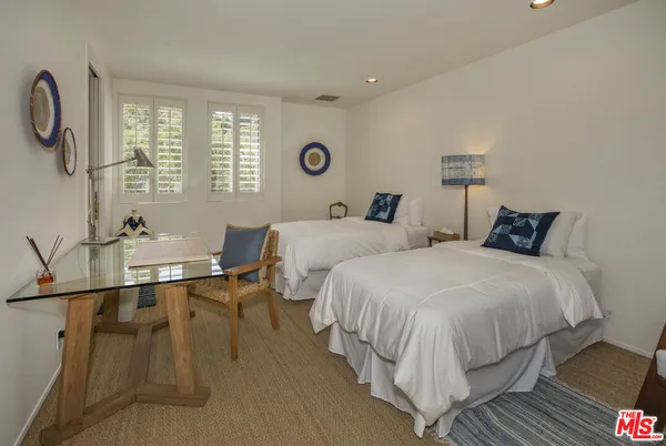 a bedroom with double bed and a window