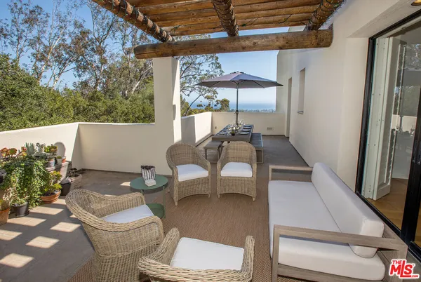 a outdoor living space with furniture and a potted plant