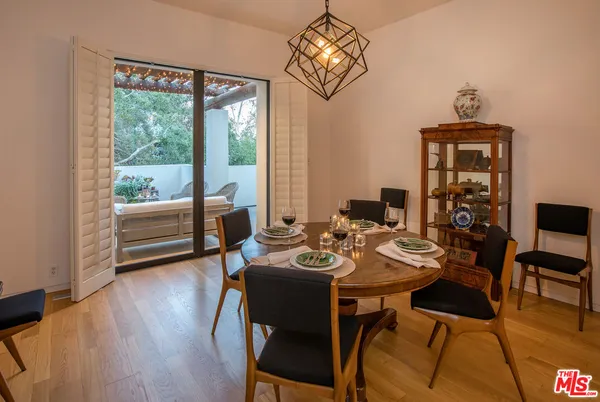 a view of a dining room with furniture wooden floor and chandelier