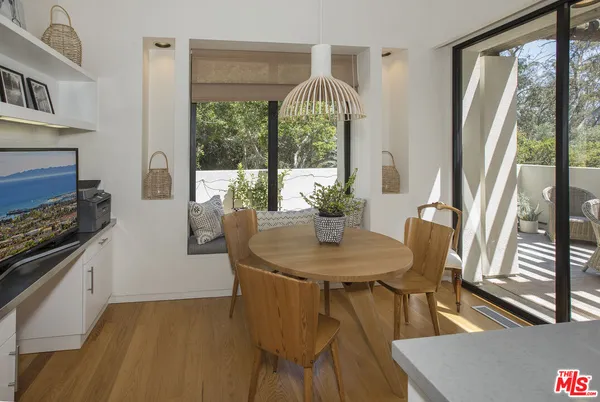 a view of a dining room with furniture window and wooden floor