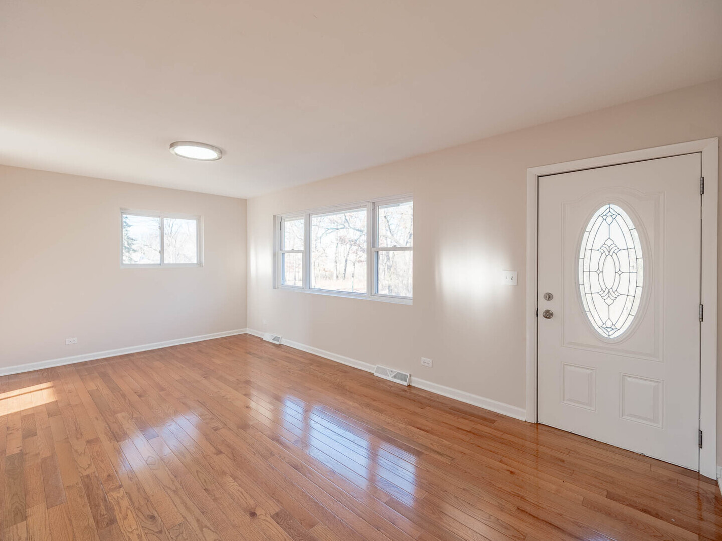 191 Juneway Terrace Lake Bluff, IL 60044 - Photo 2 of 11 an empty room with wooden floor and window