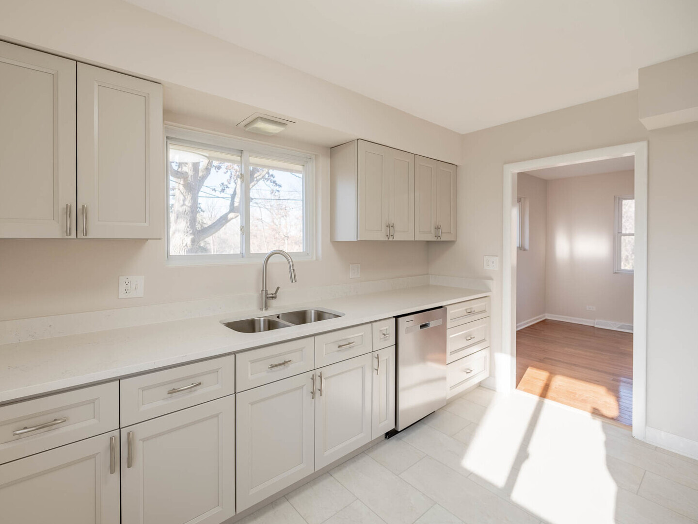 191 Juneway Terrace Lake Bluff, IL 60044 - Photo 3 of 11 a kitchen with white cabinets and a window
