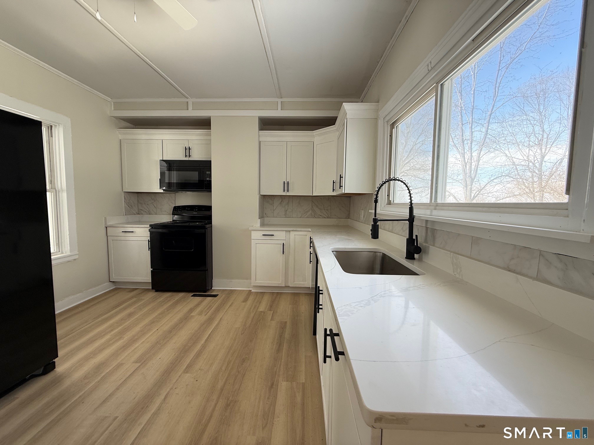 365-367 Putnam Road Plainfield, CT 06387 - Photo 12 of 40 a kitchen with stainless steel appliances a sink a stove a refrigerator cabinets and a window