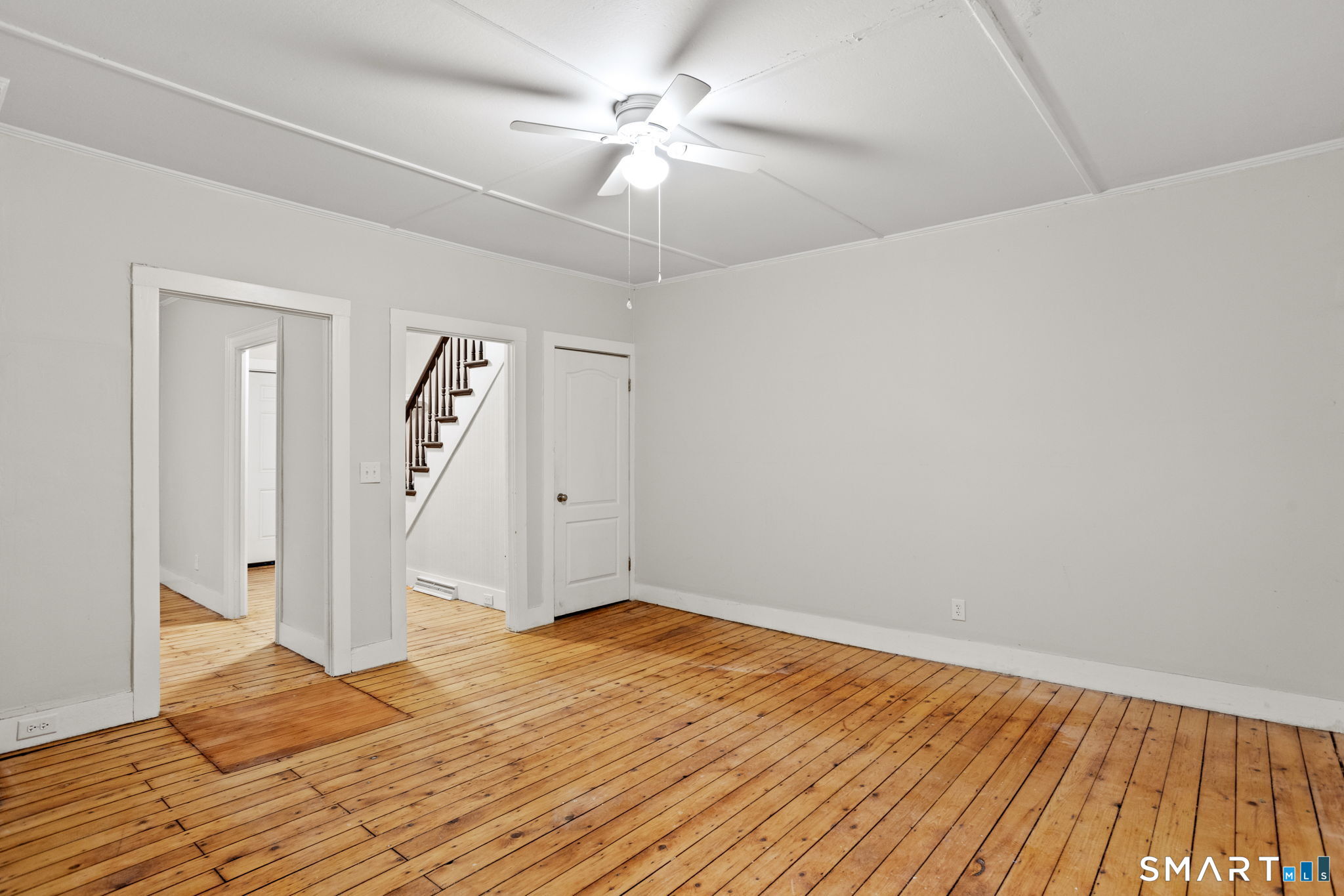 365-367 Putnam Road Plainfield, CT 06387 - Photo 22 of 40 a view of a room with wooden floor and a ceiling fan