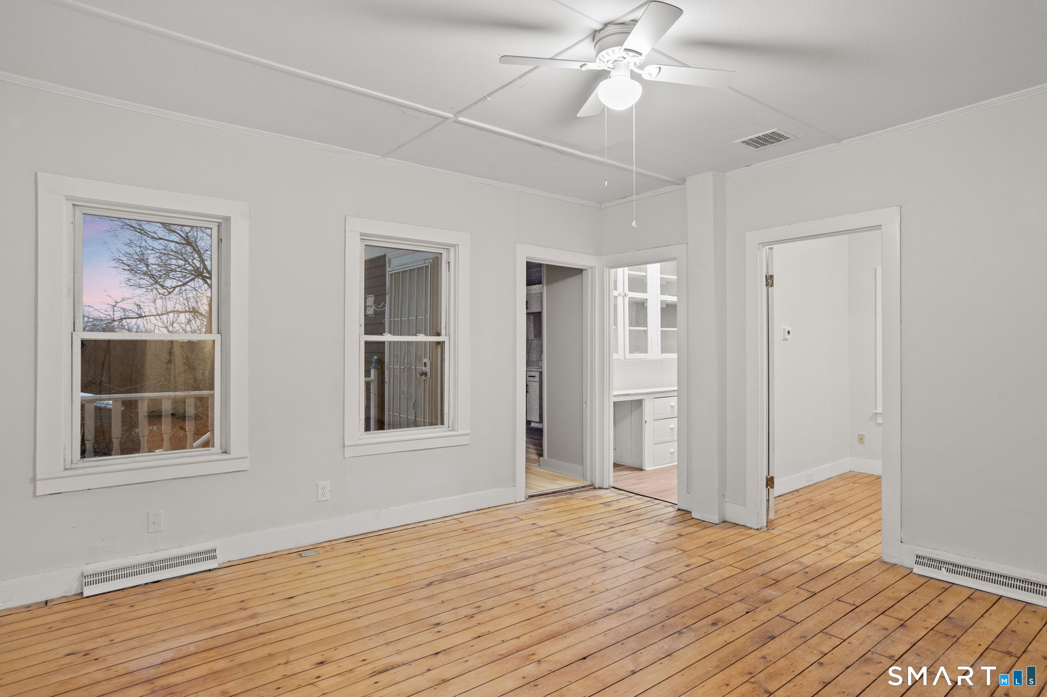 365-367 Putnam Road Plainfield, CT 06387 - Photo 23 of 40 a view of an empty room with wooden floor and a window