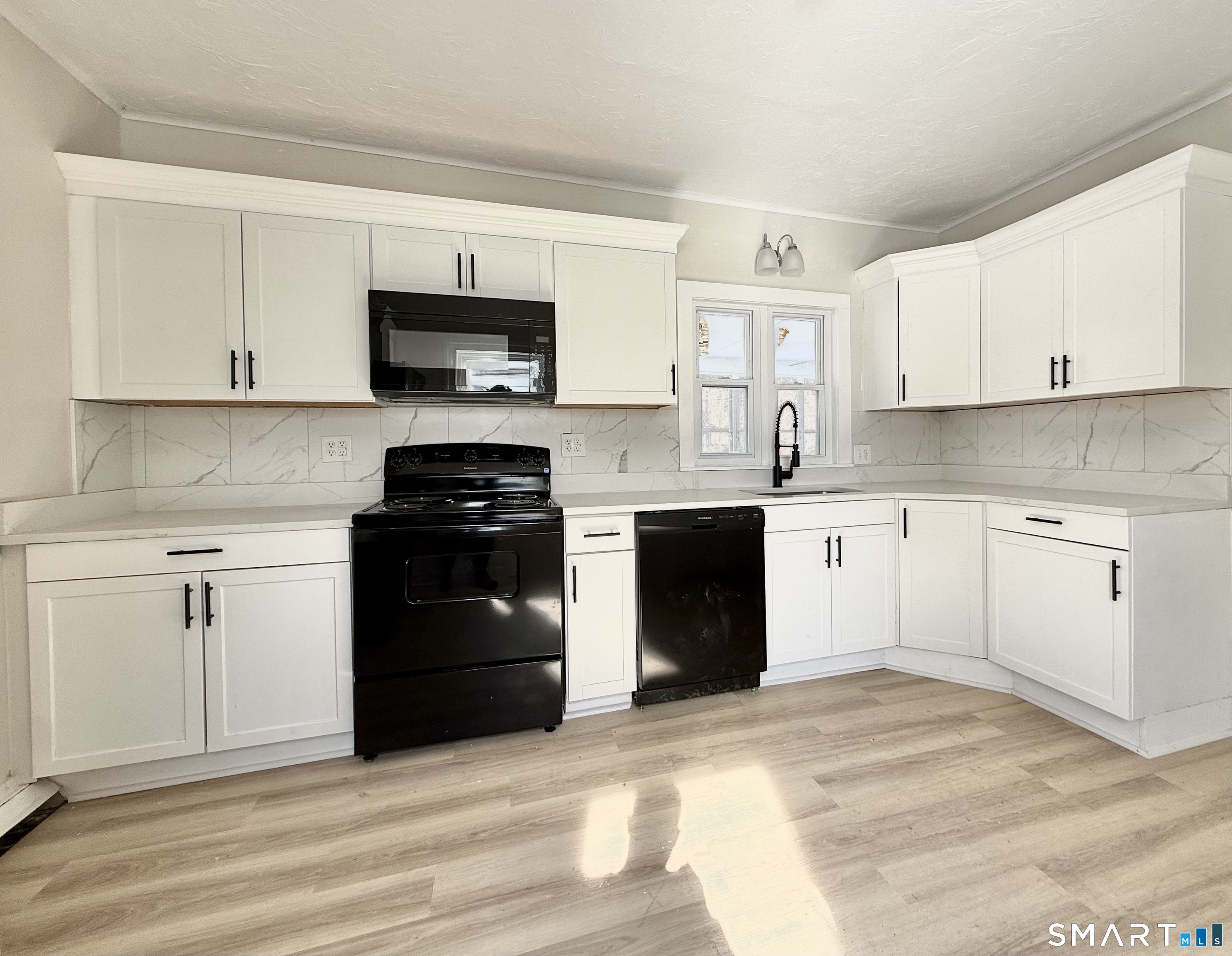 365-367 Putnam Road Plainfield, CT 06387 - Photo 25 of 40 a kitchen with cabinets stainless steel appliances and a counter space