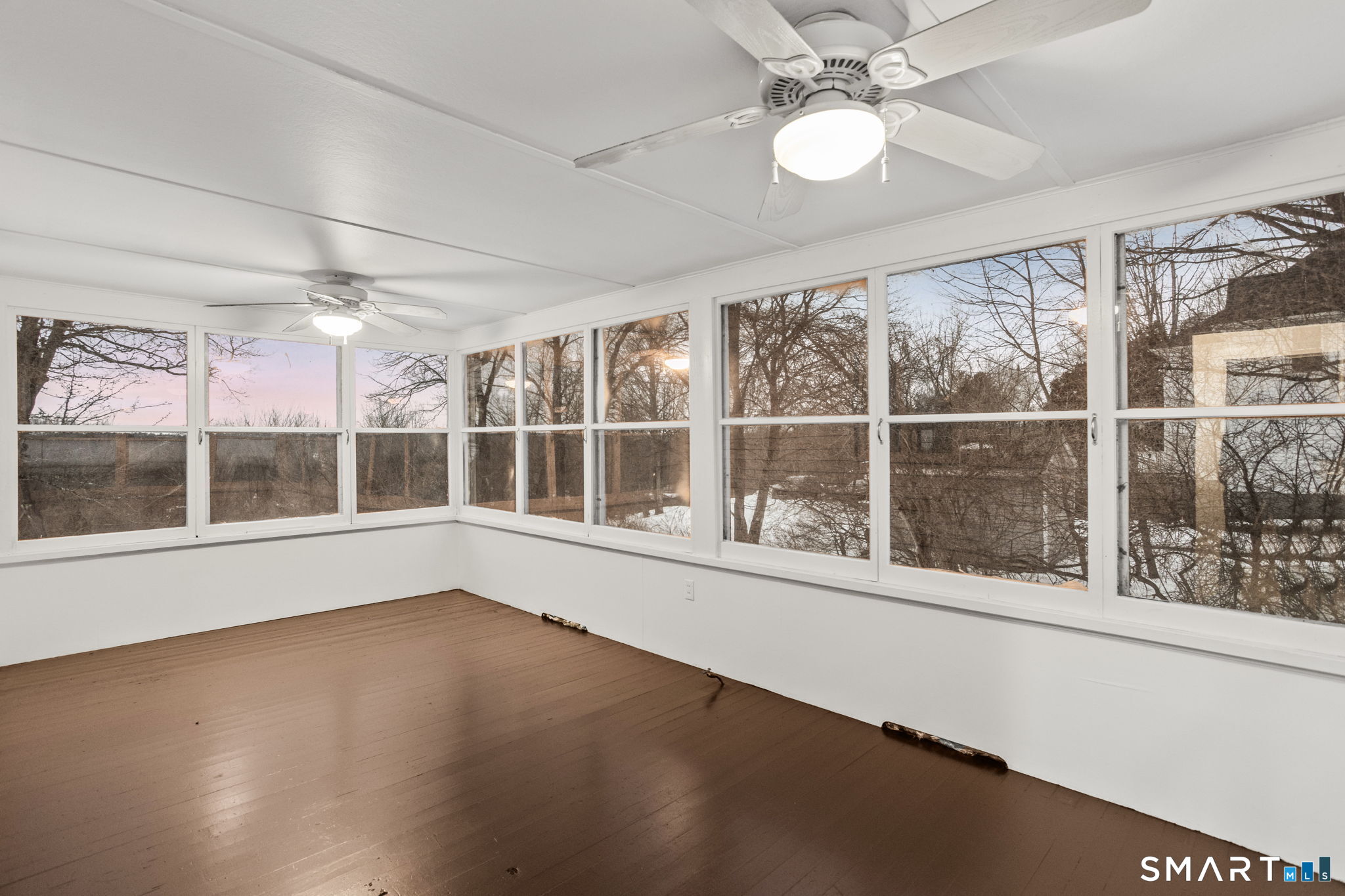 365-367 Putnam Road Plainfield, CT 06387 - Photo 27 of 40 a view of an empty room with a window and wooden floor