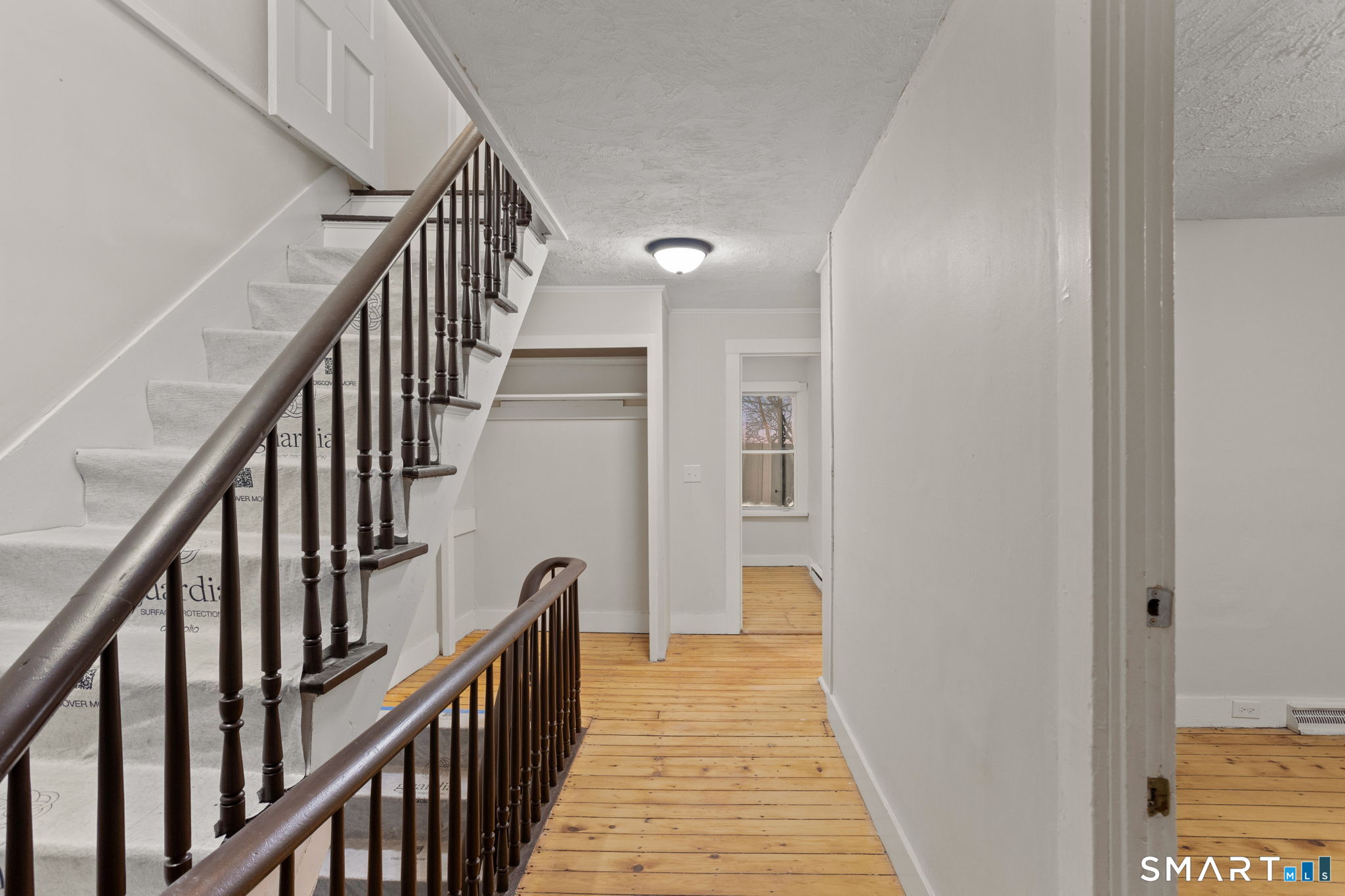 365-367 Putnam Road Plainfield, CT 06387 - Photo 28 of 40 a view of a hallway with wooden floor and stairs