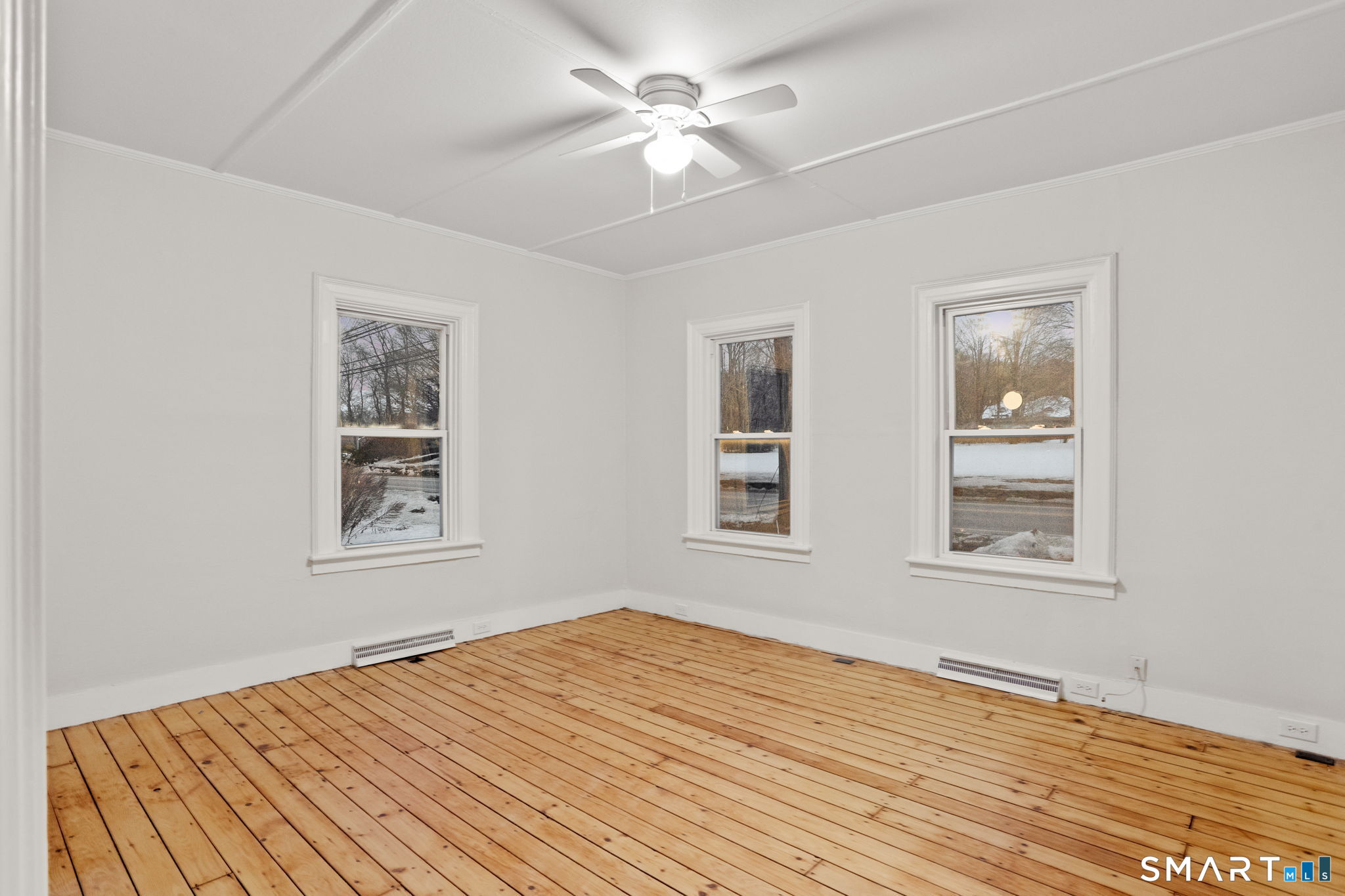 365-367 Putnam Road Plainfield, CT 06387 - Photo 29 of 40 a view of an empty room with window and a chandelier fan
