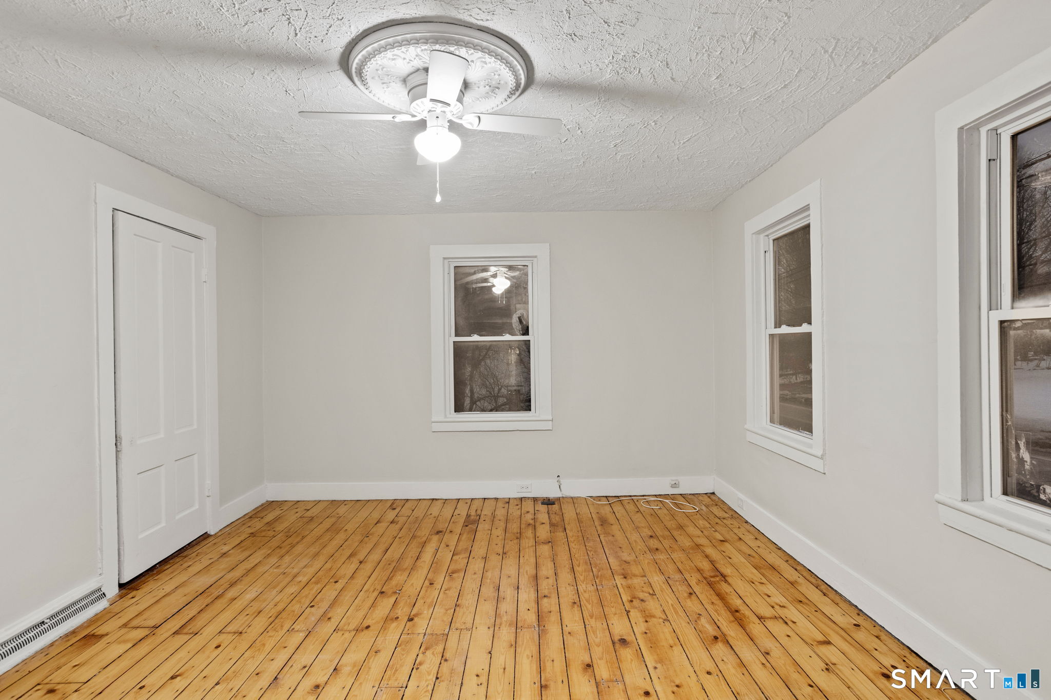 365-367 Putnam Road Plainfield, CT 06387 - Photo 32 of 40 a view of empty room with wooden floor and fan