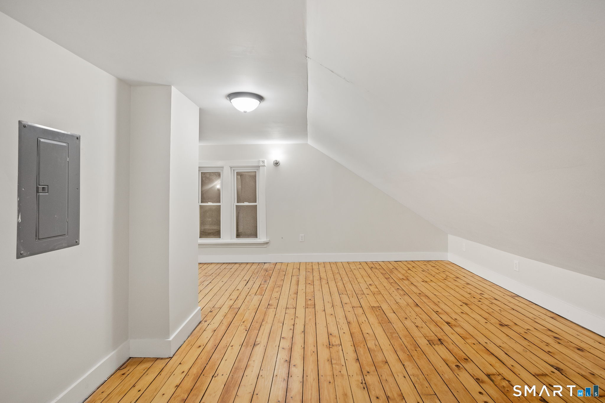 365-367 Putnam Road Plainfield, CT 06387 - Photo 34 of 40 an empty room with wooden floor and windows