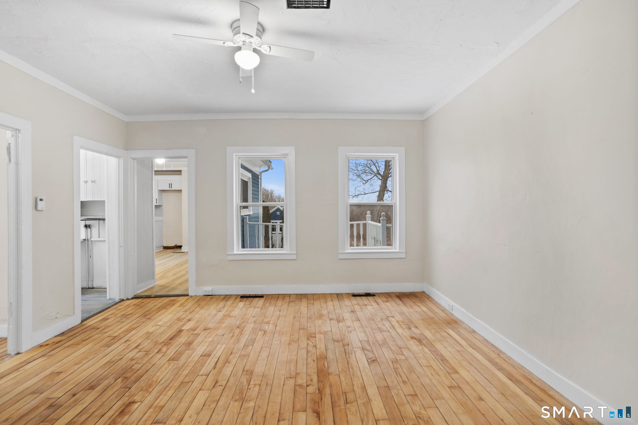 365-367 Putnam Road Plainfield, CT 06387 - Photo 8 of 40 a view of an empty room with wooden floor and a window