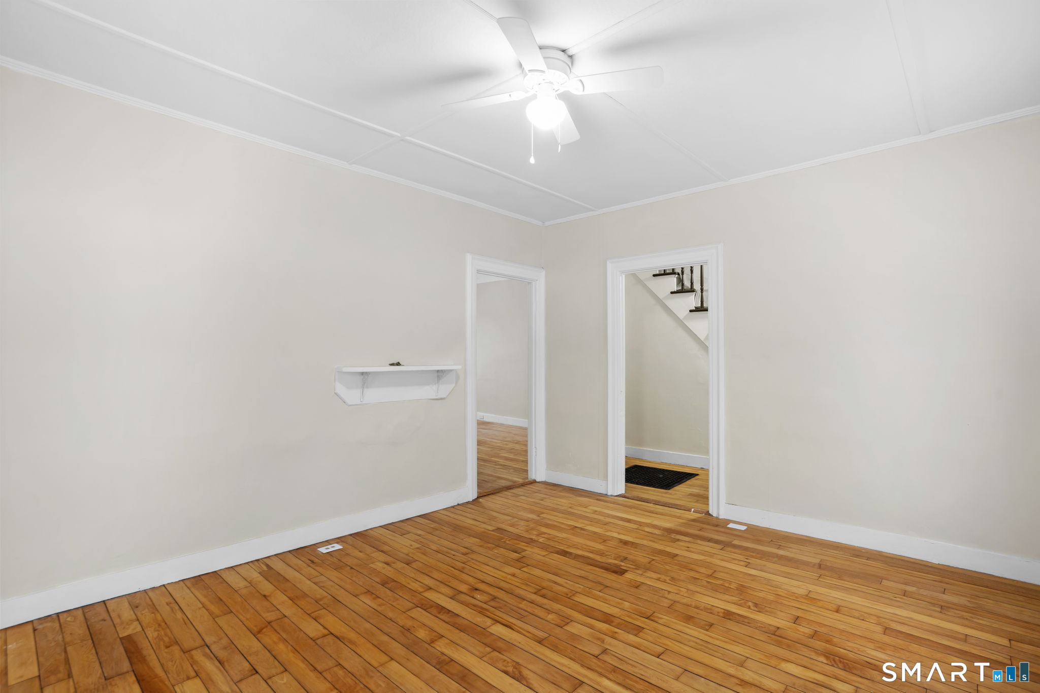 365-367 Putnam Road Plainfield, CT 06387 - Photo 9 of 40 a view of a big room with wooden floor and a ceiling fan