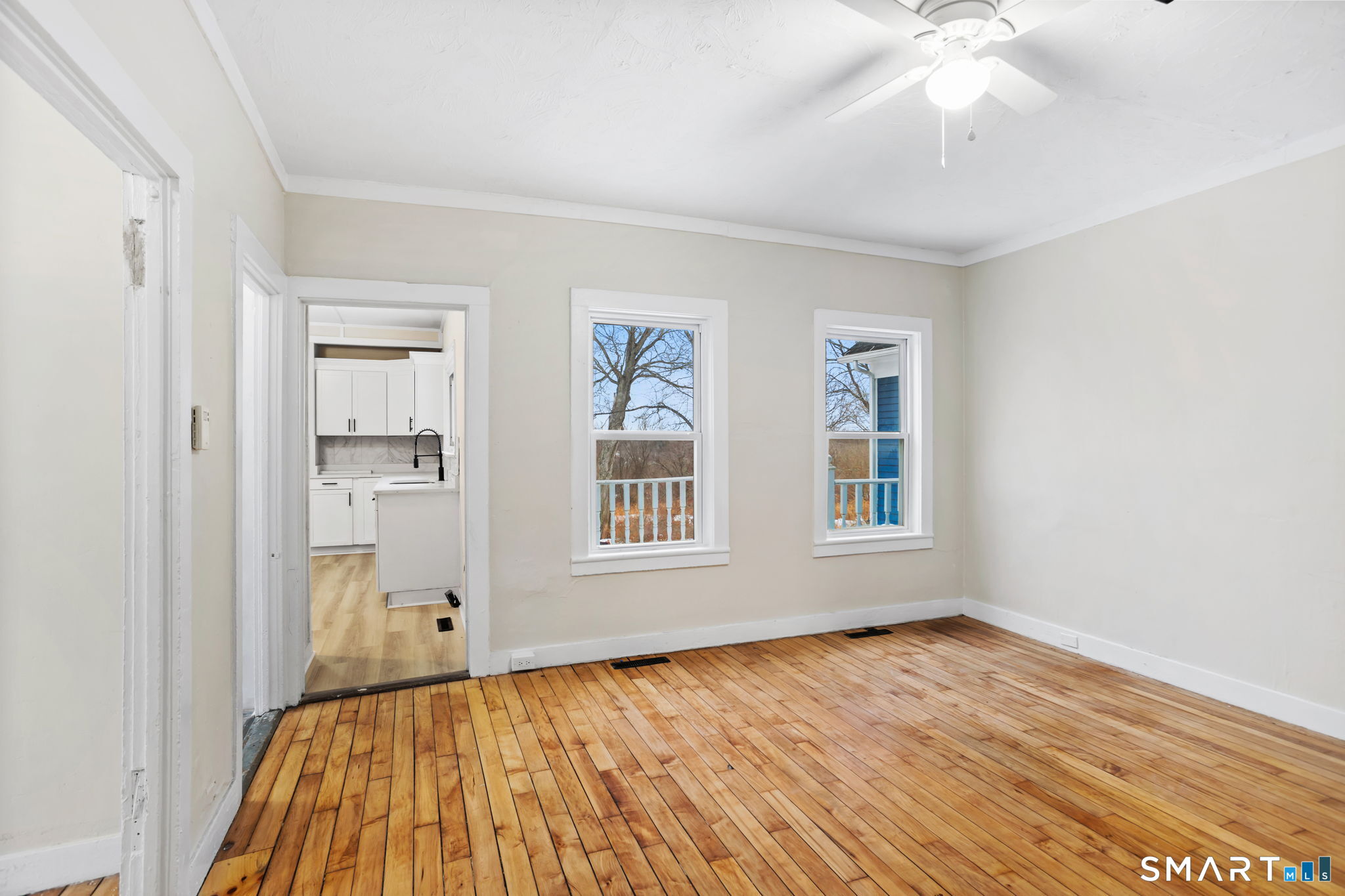 365-367 Putnam Road Plainfield, CT 06387 - Photo 10 of 40 an empty room with wooden floor chandelier and windows