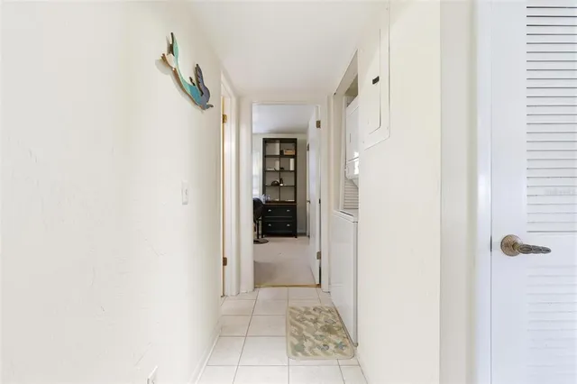 a view of a hallway with white walls and entryway