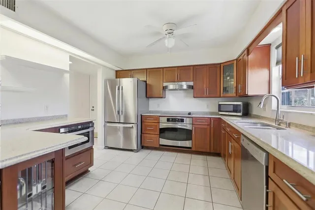a kitchen with a stove a sink and a refrigerator