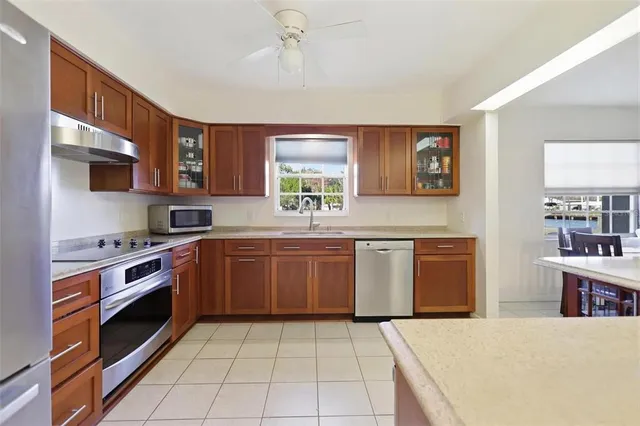 a kitchen with stainless steel appliances granite countertop a stove sink and cabinets