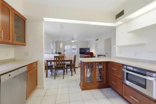 a kitchen with a sink and chairs