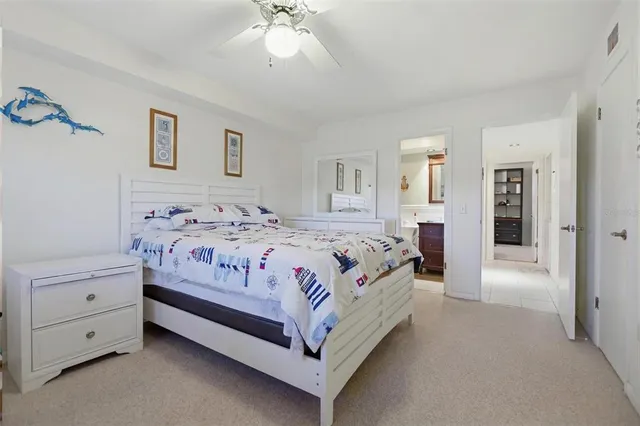 a bedroom with a large bed and a chandelier