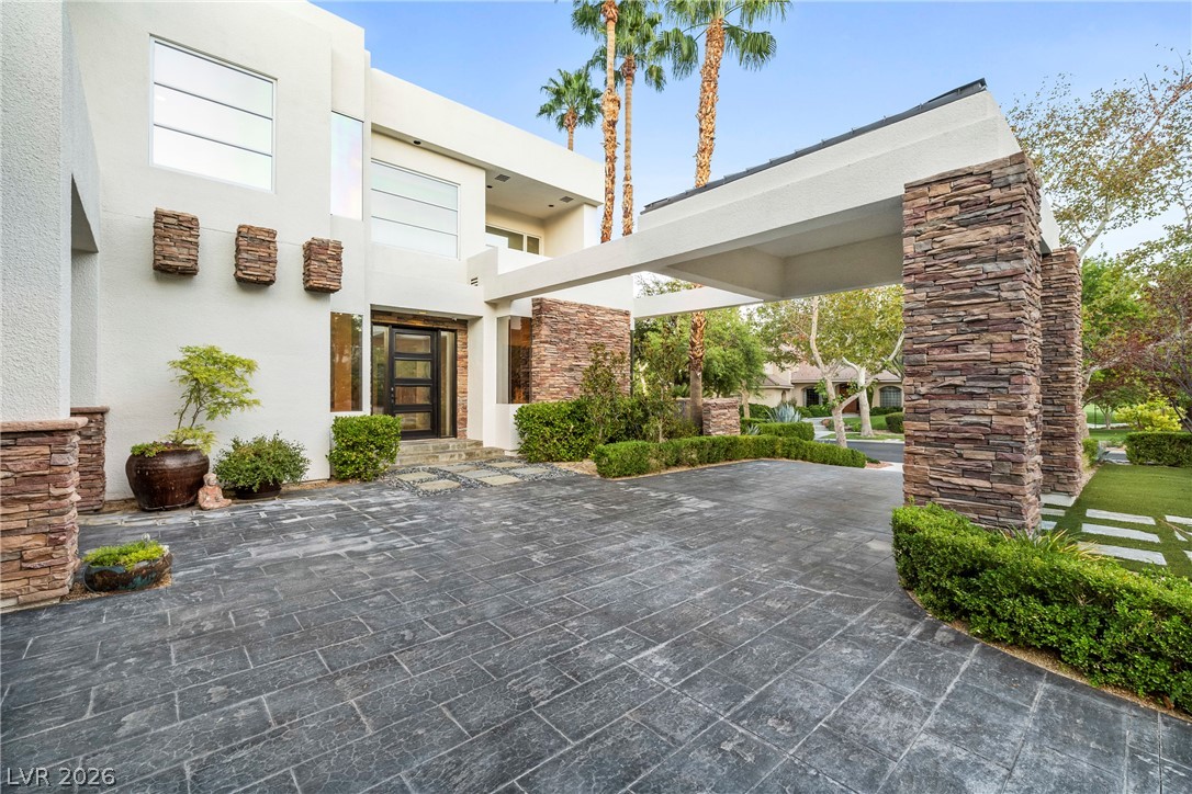 2000 Grouse Street Las Vegas, NV 89134 - Photo 49 of 89 A grand entrance welcomes you with a long, paved driveway and meticulous landscaping leading to this contemporary dwelling.