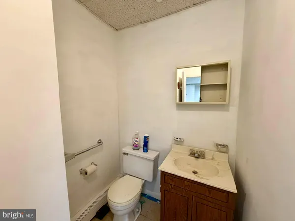 a white toilet sitting next to a bathroom sink