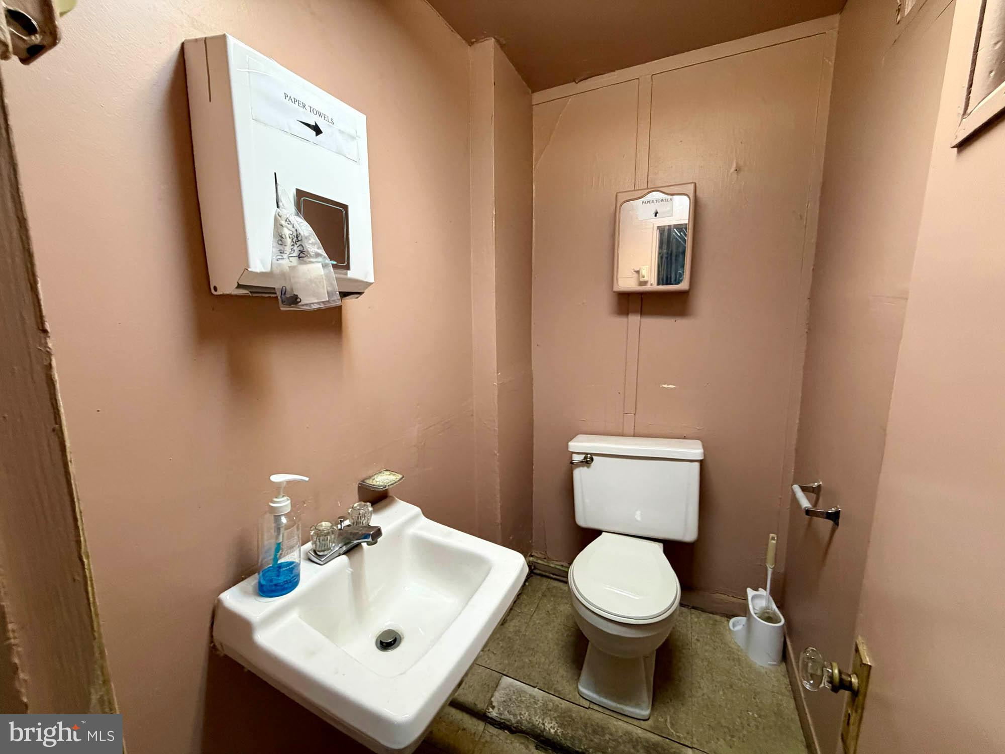 1135 Light Street Baltimore, MD 21230 - Photo 14 of 41 a white toilet sitting next to a bathroom sink