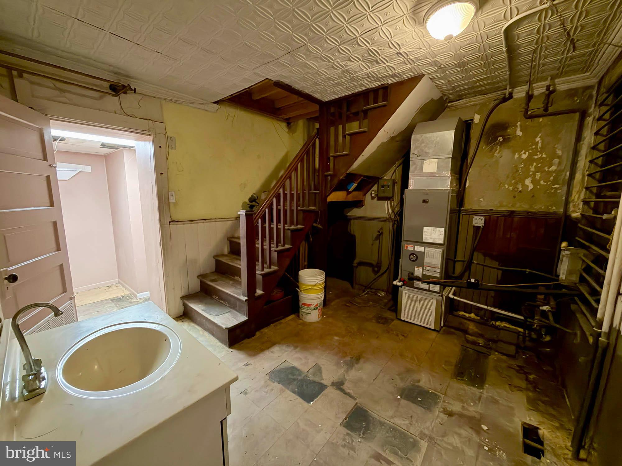 1135 Light Street Baltimore, MD 21230 - Photo 15 of 41 a bathroom with a sink mirror vanity and toilet