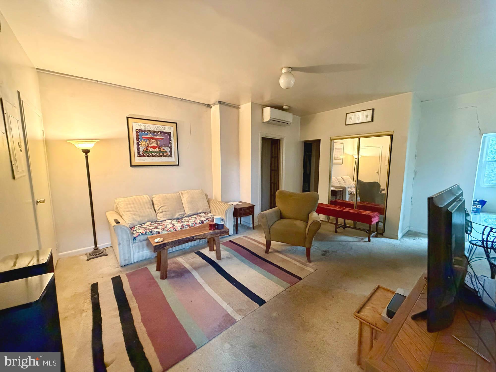 1135 Light Street Baltimore, MD 21230 - Photo 16 of 41 a living room with furniture and a floor to ceiling window