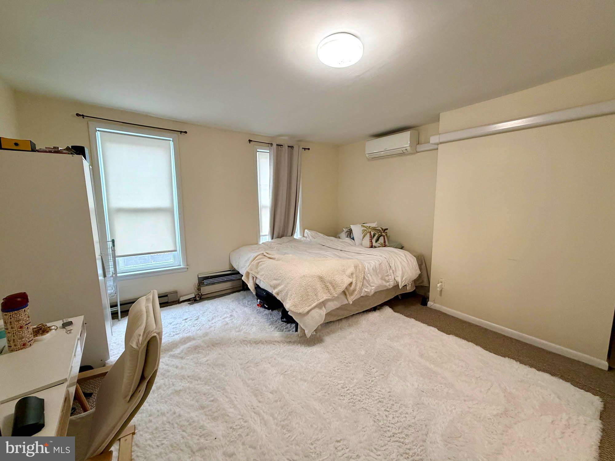 1135 Light Street Baltimore, MD 21230 - Photo 25 of 41 a bedroom with a bed and wooden floor