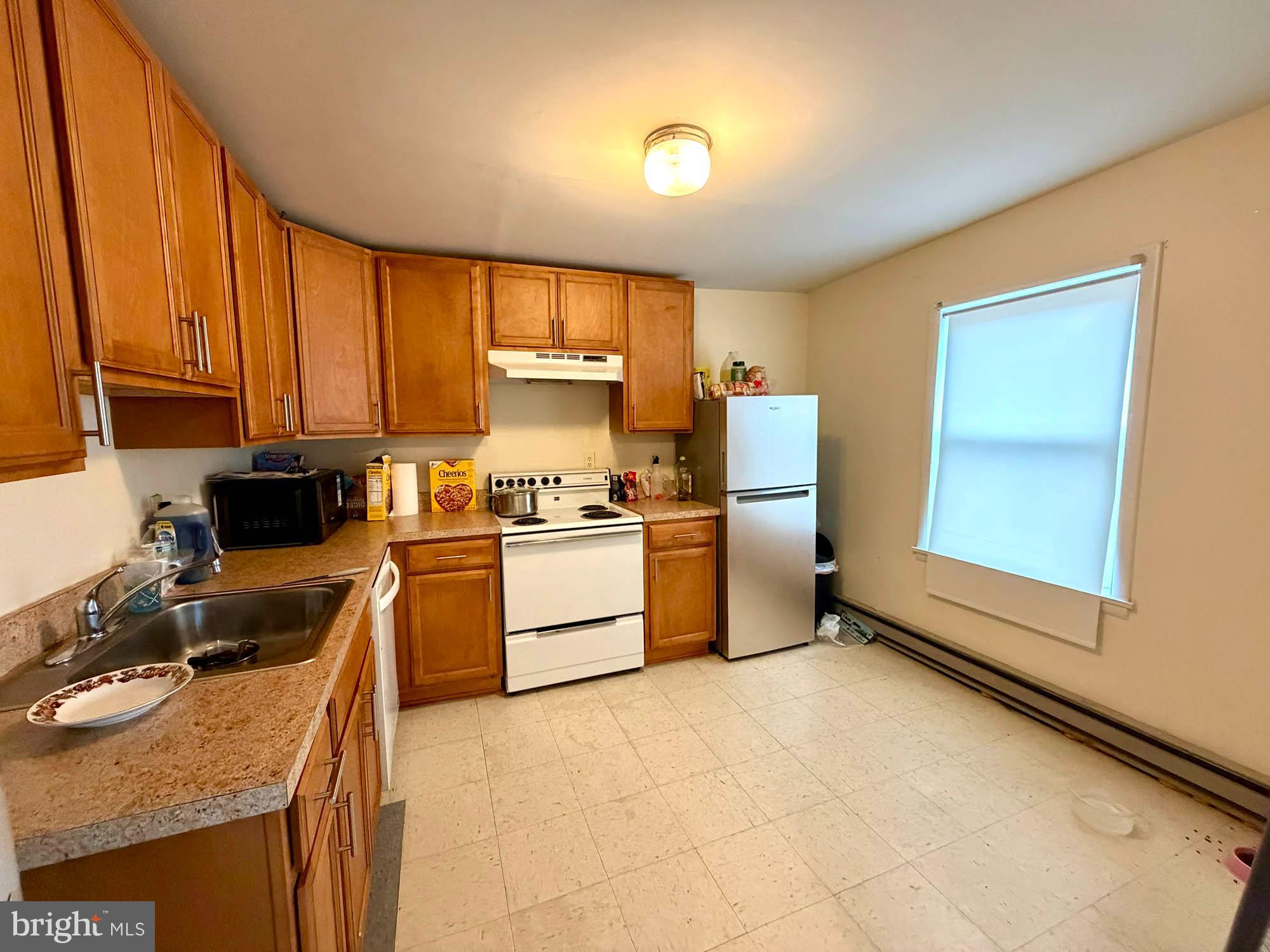 1135 Light Street Baltimore, MD 21230 - Photo 28 of 41 a kitchen with a sink appliances cabinets and furniture