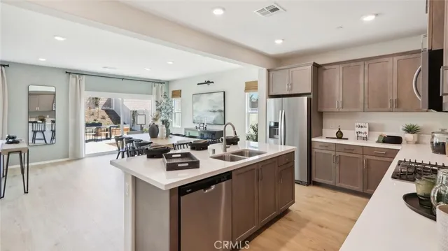 a kitchen with a sink stove and refrigerator