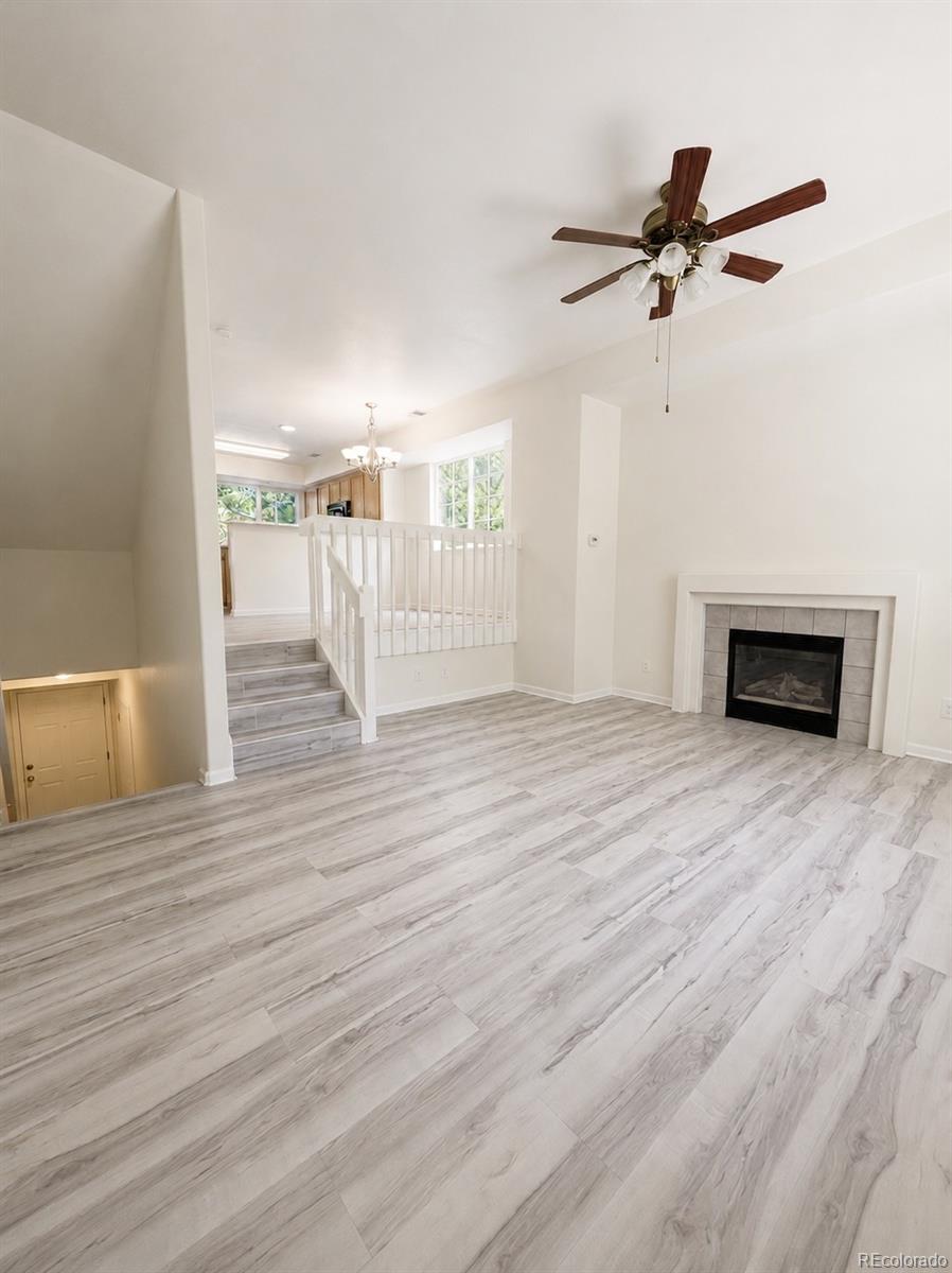8199 Welby Road, Unit 4301 Denver, CO 80229 - Photo 2 of 19 a view of empty room with wooden floor and fan