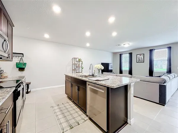 a kitchen with refrigerator and cabinets