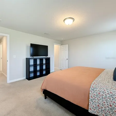 a bedroom with a bed and a lamp