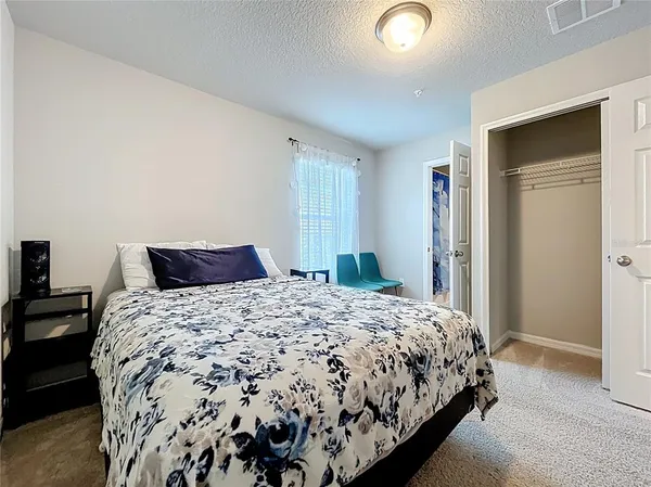 a bathroom with a granite countertop toilet sink and mirror