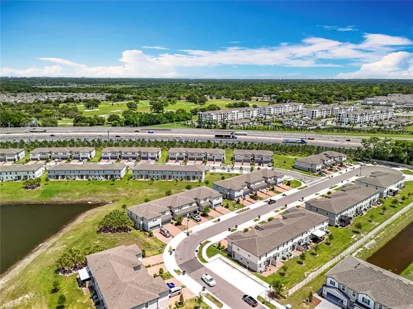a view of a house with a swimming pool and a yard