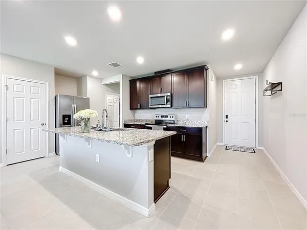 a view of living room with granite countertop furniture and kitchen view