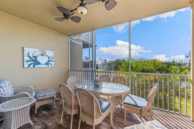 a view of a patio with couches and table and chairs under an umbrella
