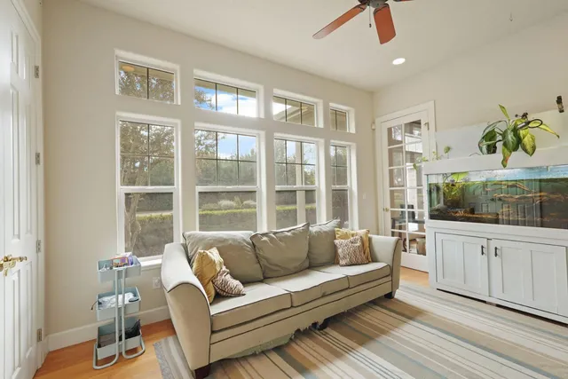 a front view of a house with yard and green space