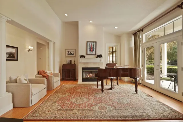 a living room with furniture a fireplace and a table